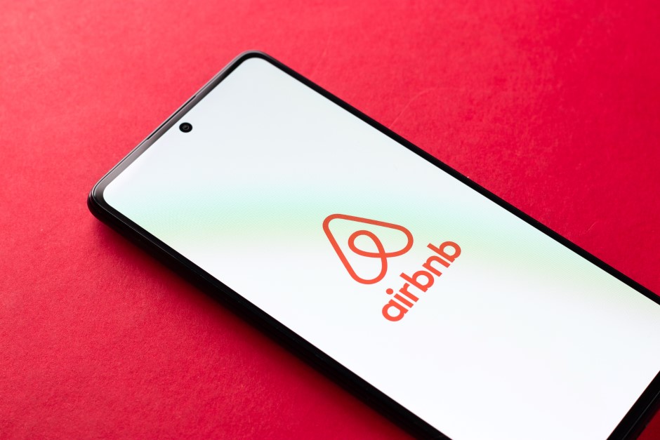 Airbnb logo on the phone screen